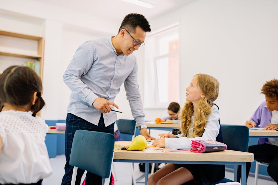 A male teacher interacting with diverse students in a bright classroom setting